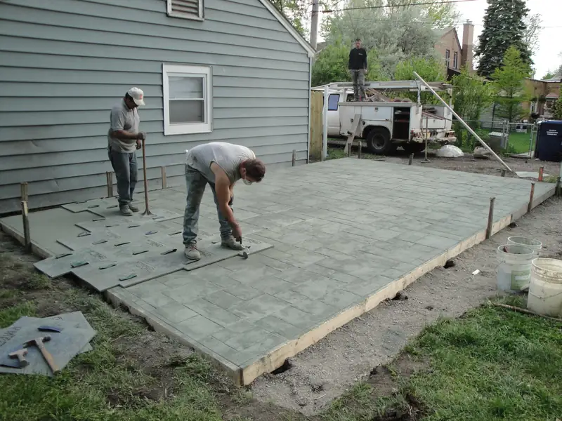A pattern mould being pressed into fresh concrete. Not a Hull driveway and not a finished surface.